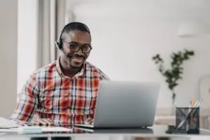 african-american-male-student-wearing-headset-learn-language-online-at-laptop-distance-education.jpg